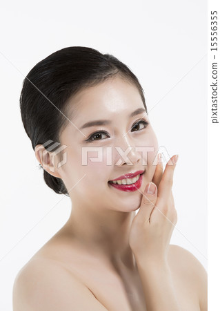 Beautiful woman cares of the skin face isolated on white background Beautiful woman cares of the skin face isolated on white background 15556355