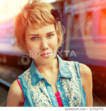 Young lovely girl at the train station 15558733