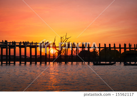Silhouettes at U Bein bridge at sunset. Myanmar  15562117