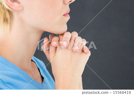 Pretty blond woman praying 15568419