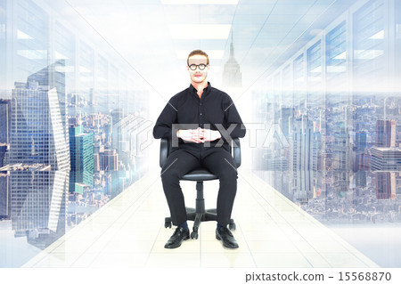 Composite image of stern businessman sitting on an office chair Composite image of stern businessman sitting on an office chair 15568870