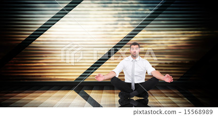 Composite image of businessman meditating in lotus pose Composite image of businessman meditating in lotus pose 15568989