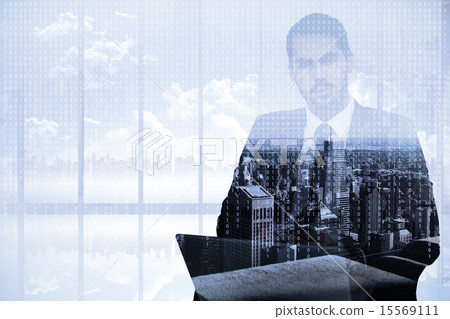 Composite image of cheerful businessman with laptop using smartp 15569111