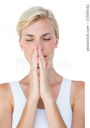 Attractive blonde woman praying 15569382