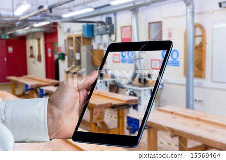 Composite image of man using tablet pc Composite image of man using tablet pc 15569464