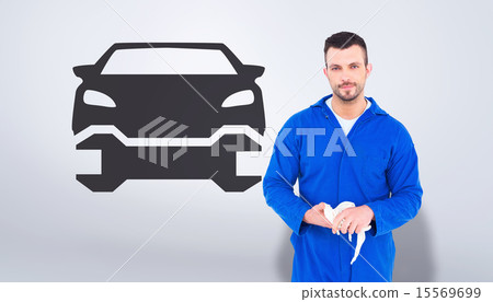 Composite image of mechanic wiping hands with cloth Composite image of mechanic wiping hands with cloth 15569699