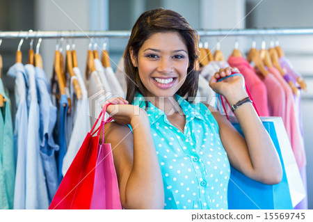 Beautiful brunette holding shopping bags Beautiful brunette holding shopping bags 15569745