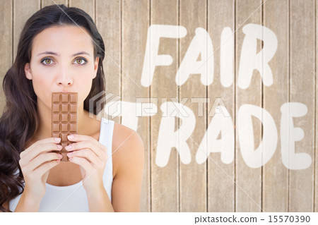 Composite image of pretty brunette eating bar of chocolate Composite image of pretty brunette eating bar of chocolate 15570390