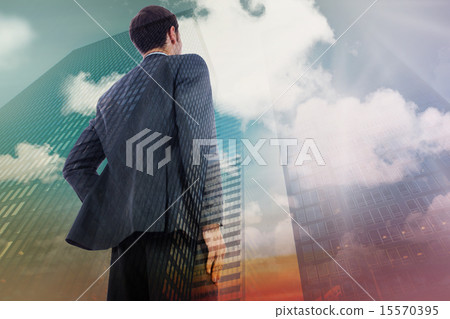 Composite image of businessman standing with hand on hip Composite image of businessman standing with hand on hip 15570395