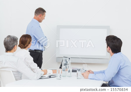 Business team looking at white screen Business team looking at white screen 15570834