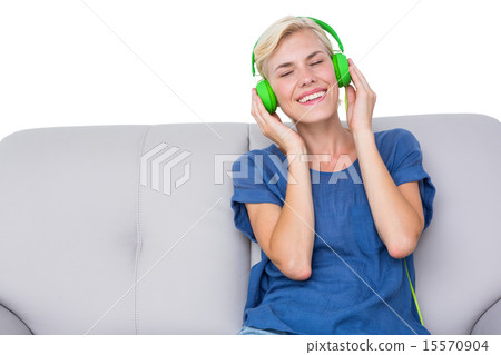 Happy woman listening music on the couch 15570904