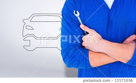 Composite image of male mechanic holding spanner on white backgr Composite image of male mechanic holding spanner on white backgr 15571036