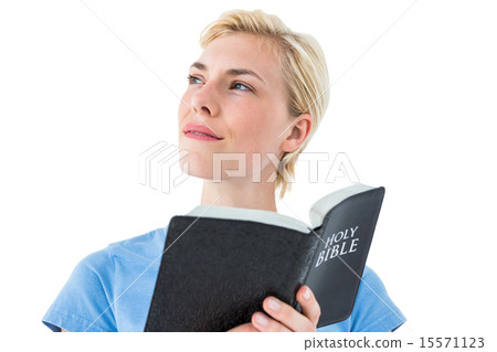 Pretty blonde woman reading bible 15571123