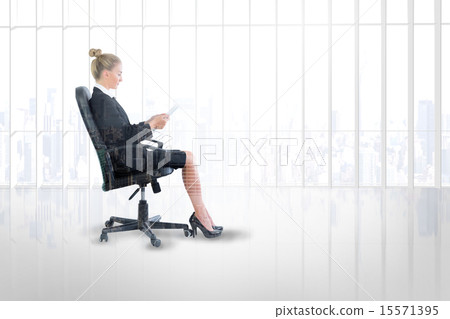 Composite image of businesswoman sitting on swivel chair with ta 15571395