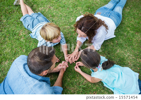 Happy family in the park together Happy family in the park together 15571454