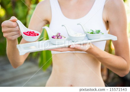 Fit woman holding plate with herbal medicine Fit woman holding plate with herbal medicine 15571543