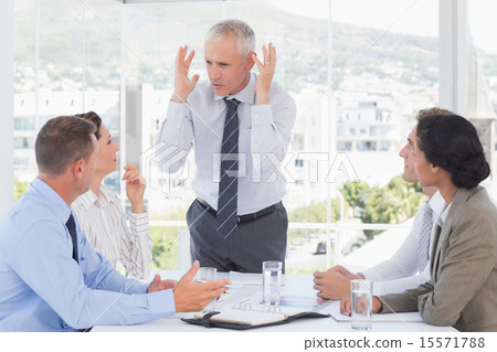 Irritated businessman talking to his team Irritated businessman talking to his team 15571788