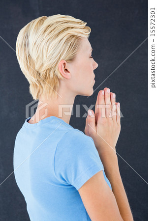 Pretty blond woman praying 15572301