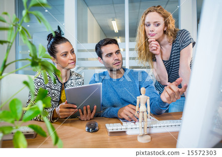 Concentrated business team working together Concentrated business team working together 15572303