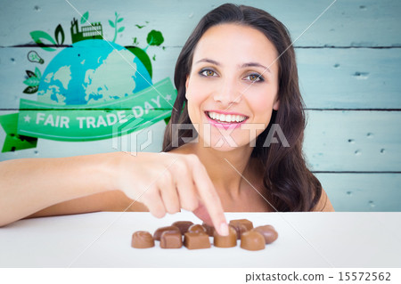 Composite image of pretty brunette picking out chocolate Composite image of pretty brunette picking out chocolate 15572562