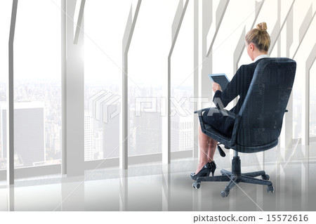 Composite image of businesswoman sitting on swivel chair with ta 15572616