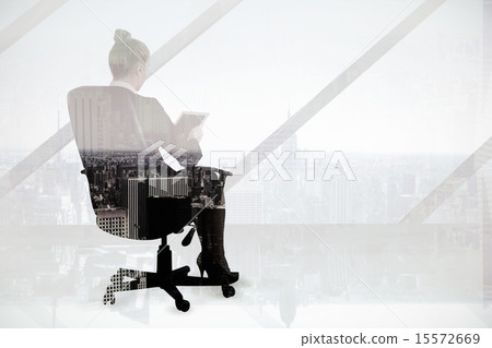 Composite image of businesswoman sitting on swivel chair with ta 15572669