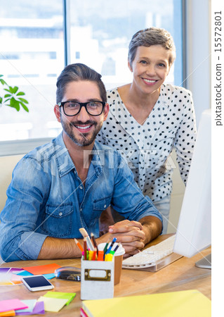 Stock Photo: Casual business team smiling at camera