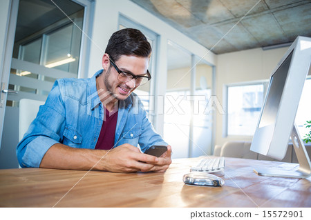 Casual businessman texting with his mobile phone 15572901