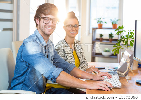 Smiling casual business team working together 15573366