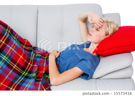 Attractive blonde woman having headache on the couch 15573416