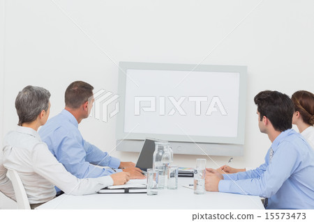 Business team looking at white screen 15573473