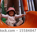 A girl challenging to slide 15584847