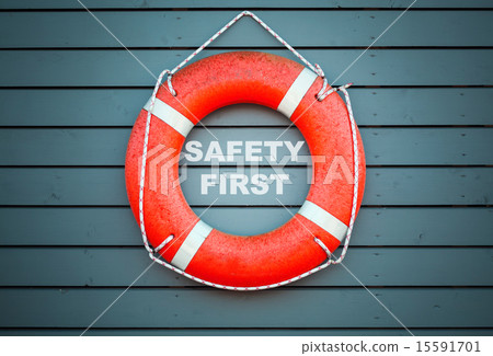 Safety first. Red lifebuoy hanging on blue wall 15591701