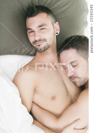 A homosexual couple onder a bed in studio white 15593345