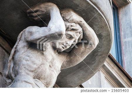 Sculpture of Atlant on facade of the old building 15605403