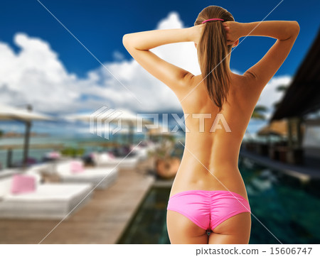 Woman topless on poolside jetty at Seychelles 15606747
