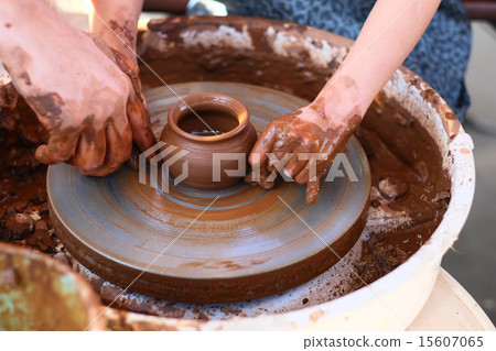 Hands working on pottery wheel Hands working on pottery wheel 15607065