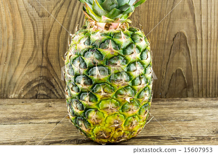 Ripe tasty pineapple lie on a wooden background Ripe tasty pineapple lie on a wooden background 15607953