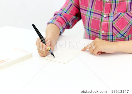 Female writing a New Year's card 15613147