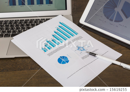Financial charts on the table with tablet  15619255