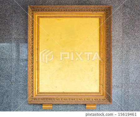 Antique golden frame on wall 15619461