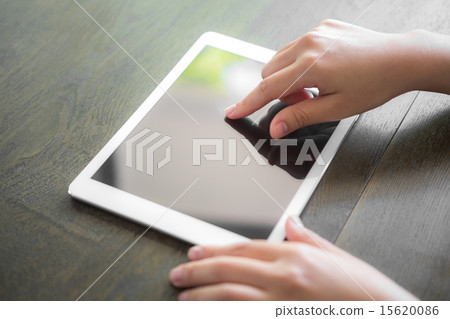 Woman hand touch white tablet with blank screen Woman hand touch white tablet with blank screen 15620086
