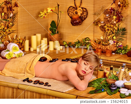 Woman getting stone therapy massage . 15624015