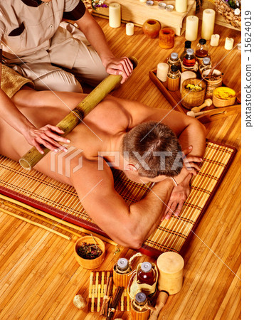 Woman getting bamboo massage. 15624019