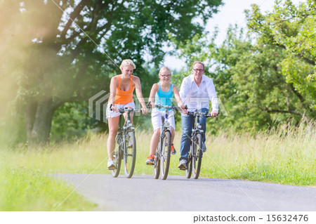 Family having weekend bicycle tour outdoors 15632476