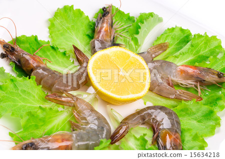 Raw shrimps on plate with lettuce Raw shrimps on plate with lettuce 15634218