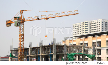 Construction site with yellow crane and workers Construction site with yellow crane and workers 15635622