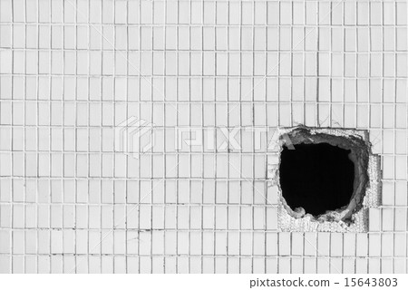 Hole on the old white wall 15643803