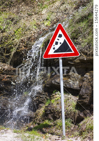 Small waterfall running behind a landslide sign 15644279