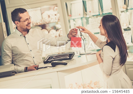 Happy woman customer in a jewellery shop Happy woman customer in a jewellery shop 15645485